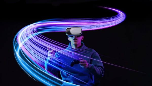 A man wearing a virtual reality headset and hoodie holds a controller as blue and purple neon lines swirl around him.